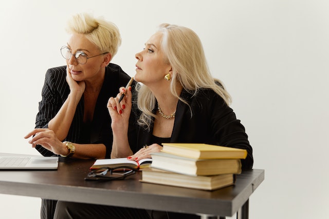 two property managers reviewing on a marketing plan on the computer